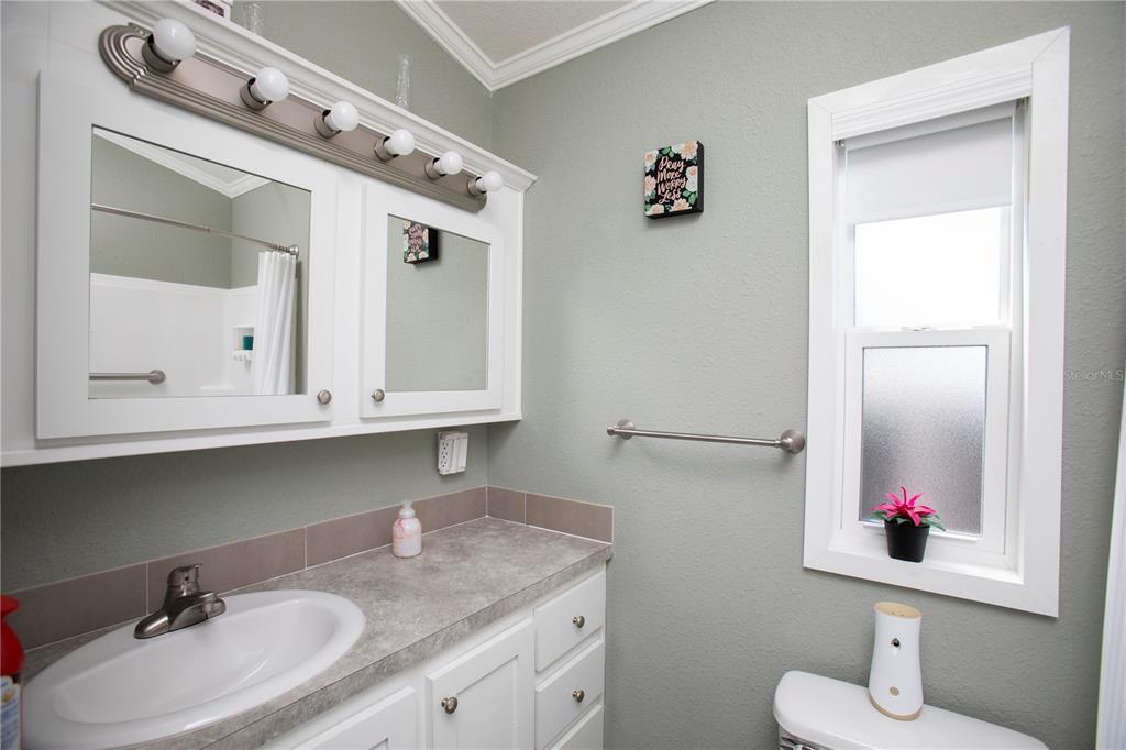 5642 Oak Ridge Avenue New Port Richey, FL 34652 - Photo 12 of 44 a bathroom with a sink vanity and mirror