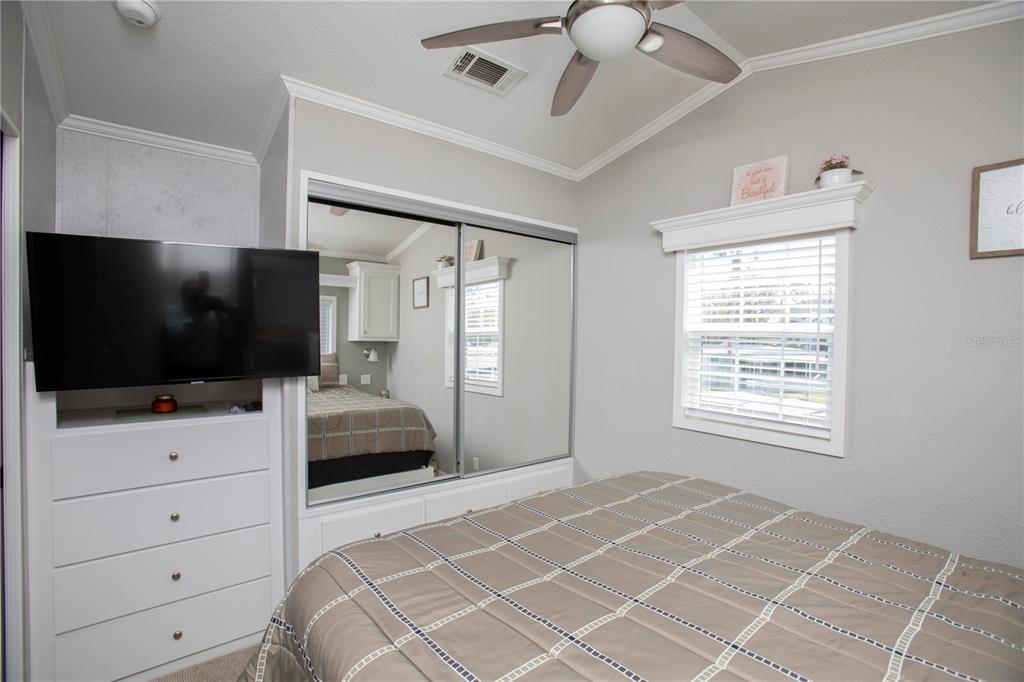 5642 Oak Ridge Avenue New Port Richey, FL 34652 - Photo 16 of 44 a bedroom with a bed and a flat screen tv