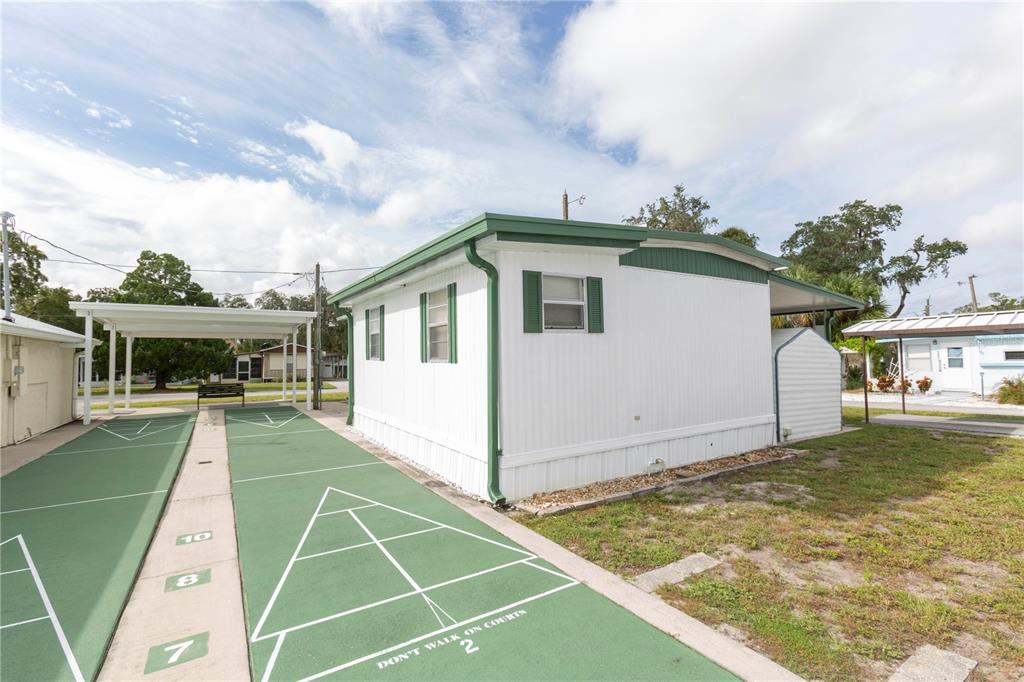 5642 Oak Ridge Avenue New Port Richey, FL 34652 - Photo 22 of 44 a view of a house with a backyard and a patio