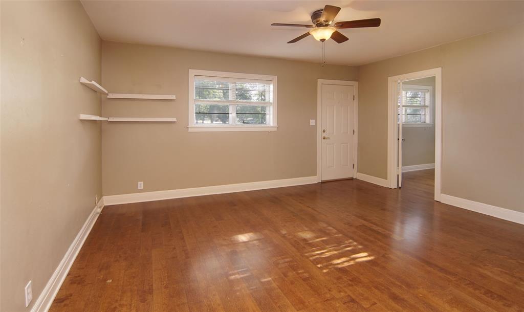730 Indiana Street Graham, TX 76450 - Photo 11 of 25 wooden floor in an empty room with a window
