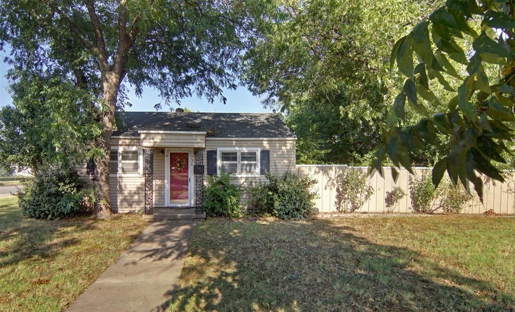 730 Indiana Street Graham, TX 76450 - Photo 2 of 25 a front view of a house with a garden