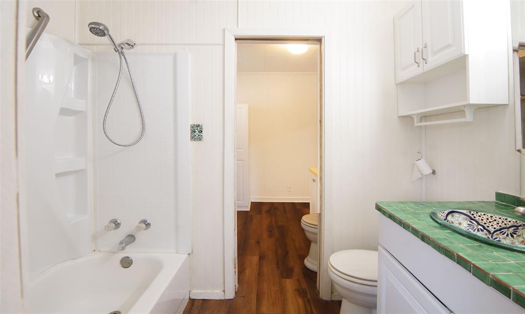 730 Indiana Street Graham, TX 76450 - Photo 3 of 25 a bathroom with a sink a toilet and shower