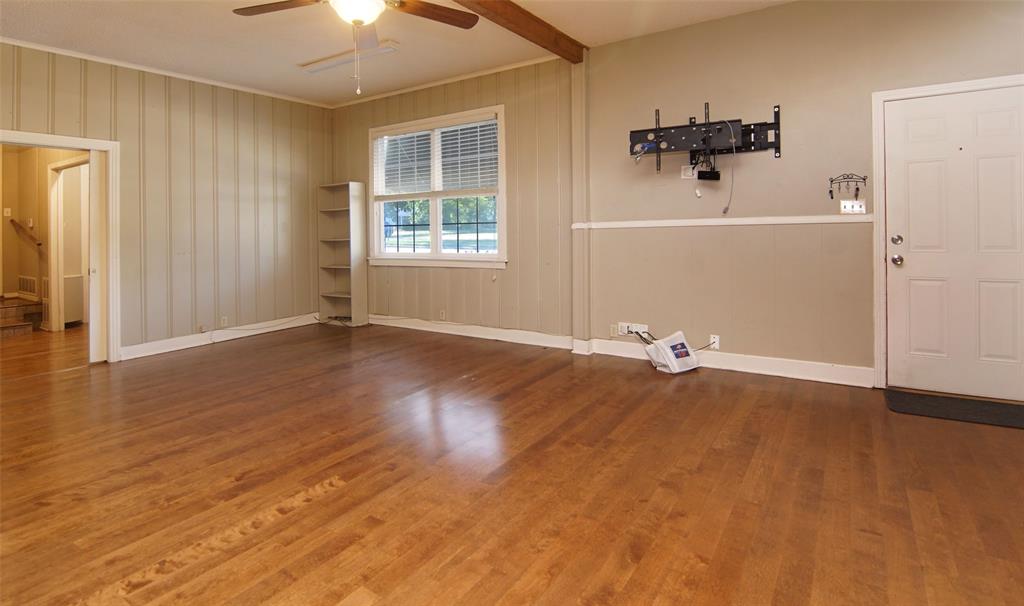 730 Indiana Street Graham, TX 76450 - Photo 9 of 25 wooden floor in an empty room with a window