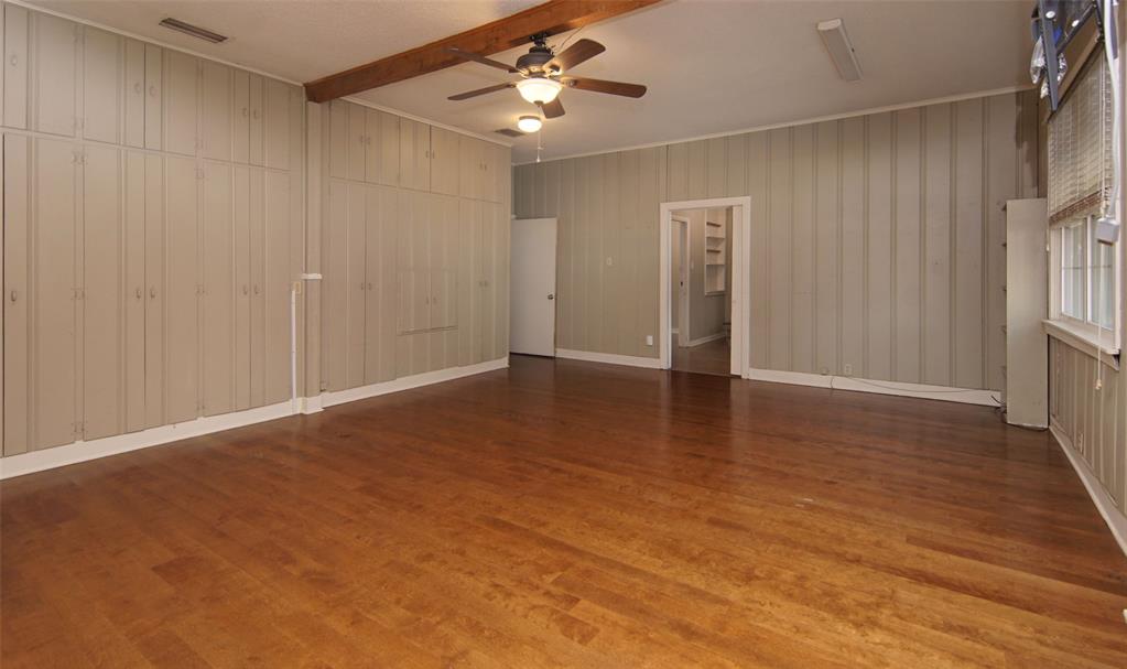 730 Indiana Street Graham, TX 76450 - Photo 10 of 25 wooden floor in an empty room with a window