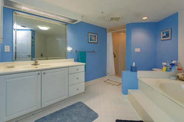 a en suite bathroom with double sink and a mirror