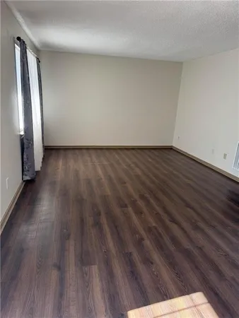 a view of wooden floor and windows in a room