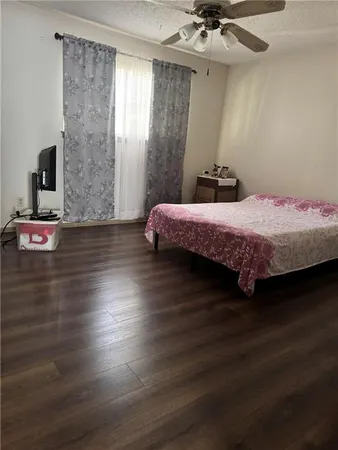 a bedroom with a bed and a ceiling fan