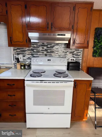 a stove top oven sitting inside of a kitchen