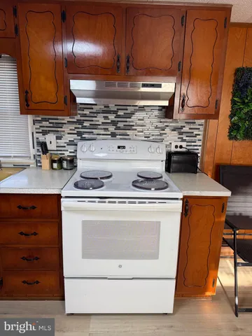 a living room with a couch dresser and a flat screen tv