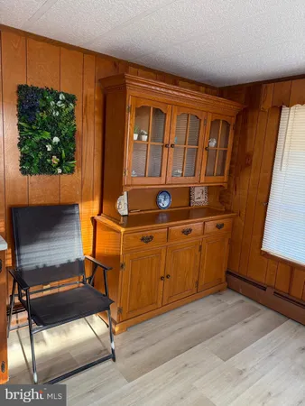 a living room with a couch dresser and a flat screen tv