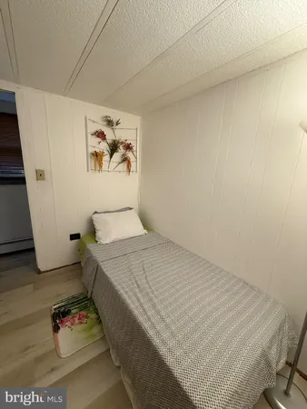 a bedroom with a bed and the wall painting