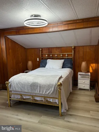 a bedroom with a bed and a view of couch