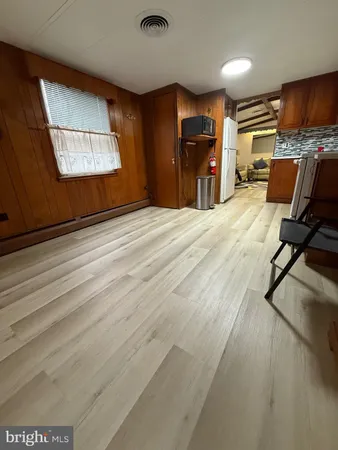 an empty room with closet and a window