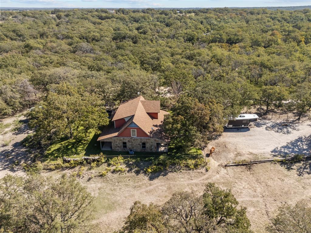 262 North Cheyenne Springtown, TX 76082 - Photo 6 of 35 View from above of property with a heavily wooded area