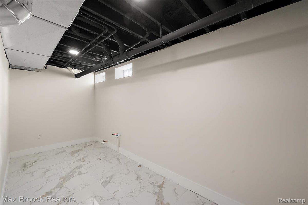 4597 Clarkston Road Clarkston, MI 48348 - Photo 57 of 74 Bright white walls with a dark exposed ceiling, recessed lighting, and white baseboards