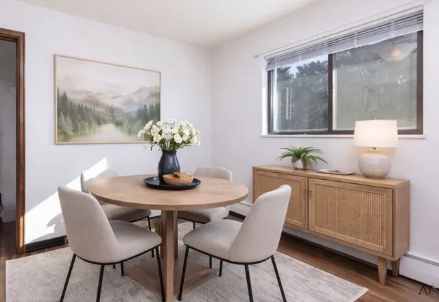 a dining room with furniture and wooden floor
