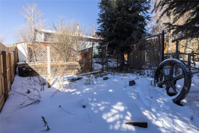 a view of a backyard with large trees