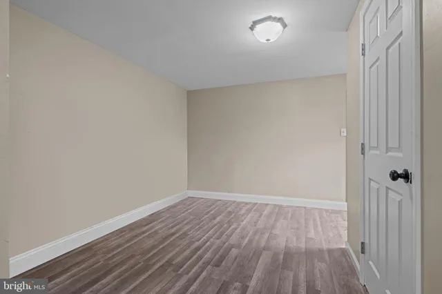 a view of a room with wooden floor