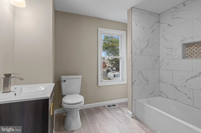 a bathroom with a toilet a sink and bathtub