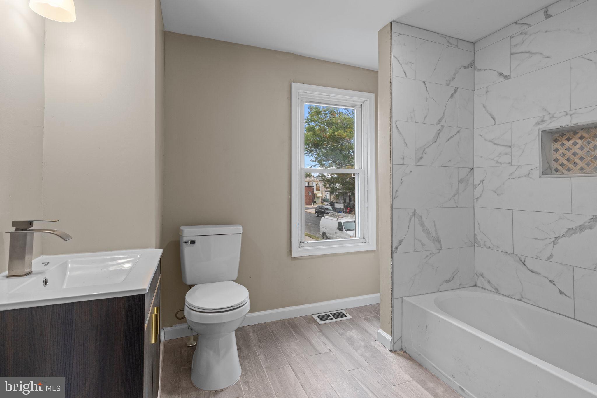 327 Mercer Street Gloucester City, NJ 08030 - Photo 16 of 19 a bathroom with a toilet a sink and bathtub