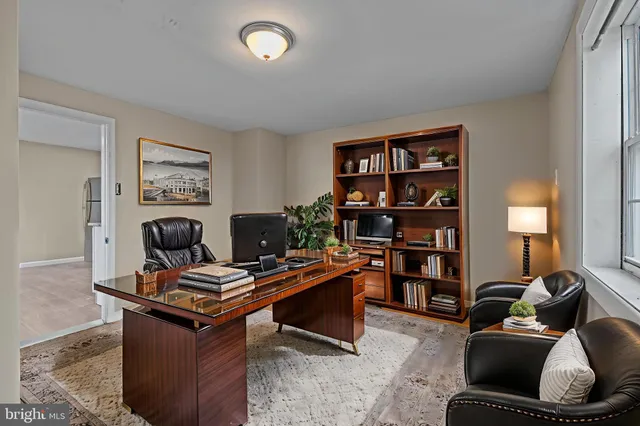 a room with furniture and a bookshelf
