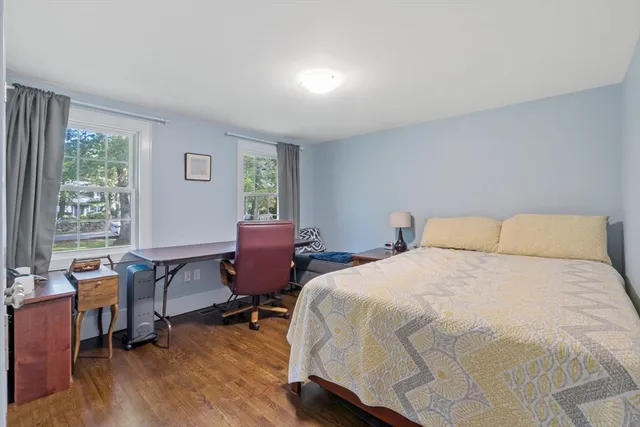 a bedroom with a bed a table and a window