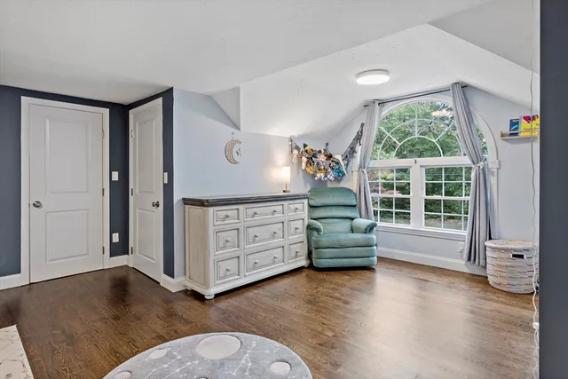 an empty room with windows wooden floor and windows