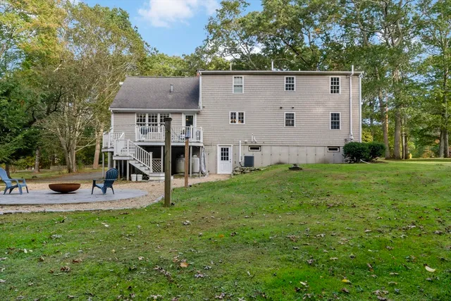 a view of a house with backyard porch and sitting area