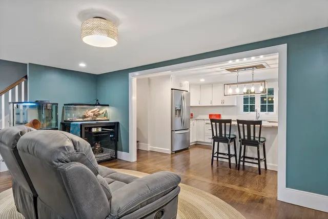 a living room with furniture and a kitchen
