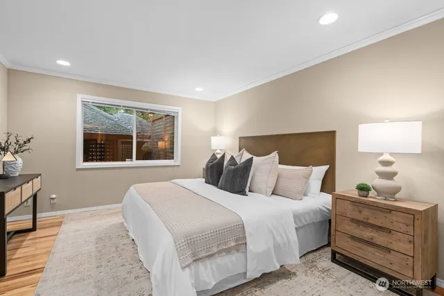 a bedroom with a bed and wooden floor