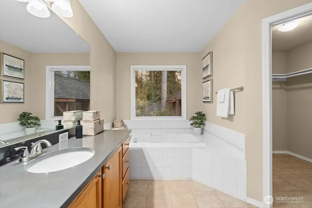 a spacious bathroom with sink and bathtub