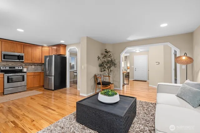 a living room with furniture kitchen and a table