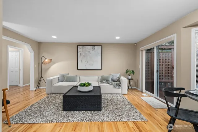 a living room with furniture and wooden floor