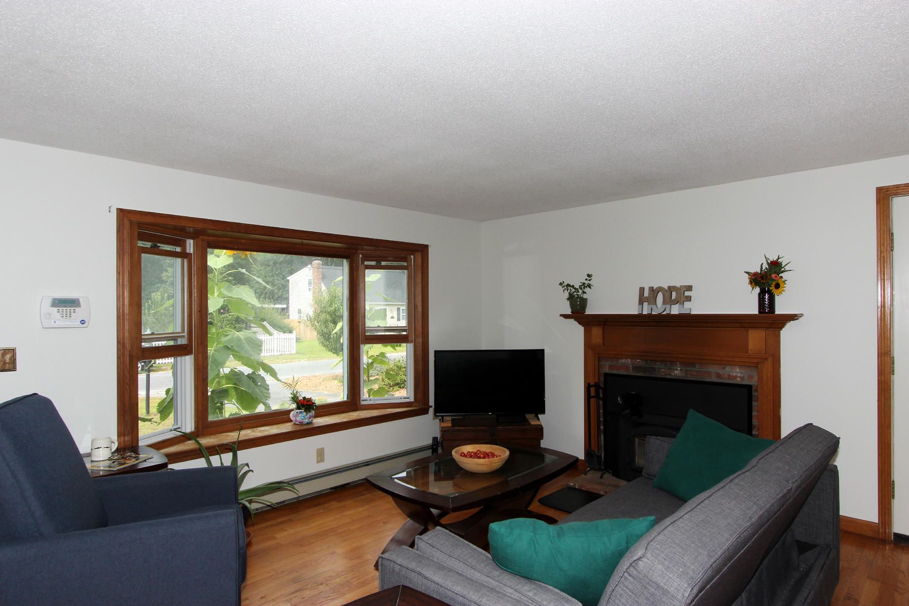 58 Colburne Path West Yarmouth, MA 02673 - Photo 18 of 39 a living room with furniture a fireplace and a flat screen tv