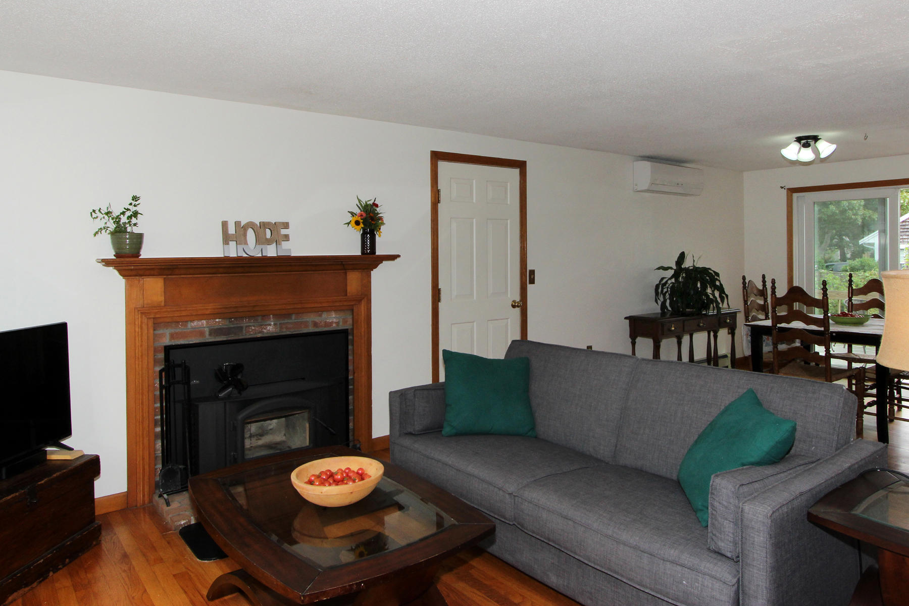 58 Colburne Path West Yarmouth, MA 02673 - Photo 20 of 39 a living room with furniture a fireplace and a flat screen tv