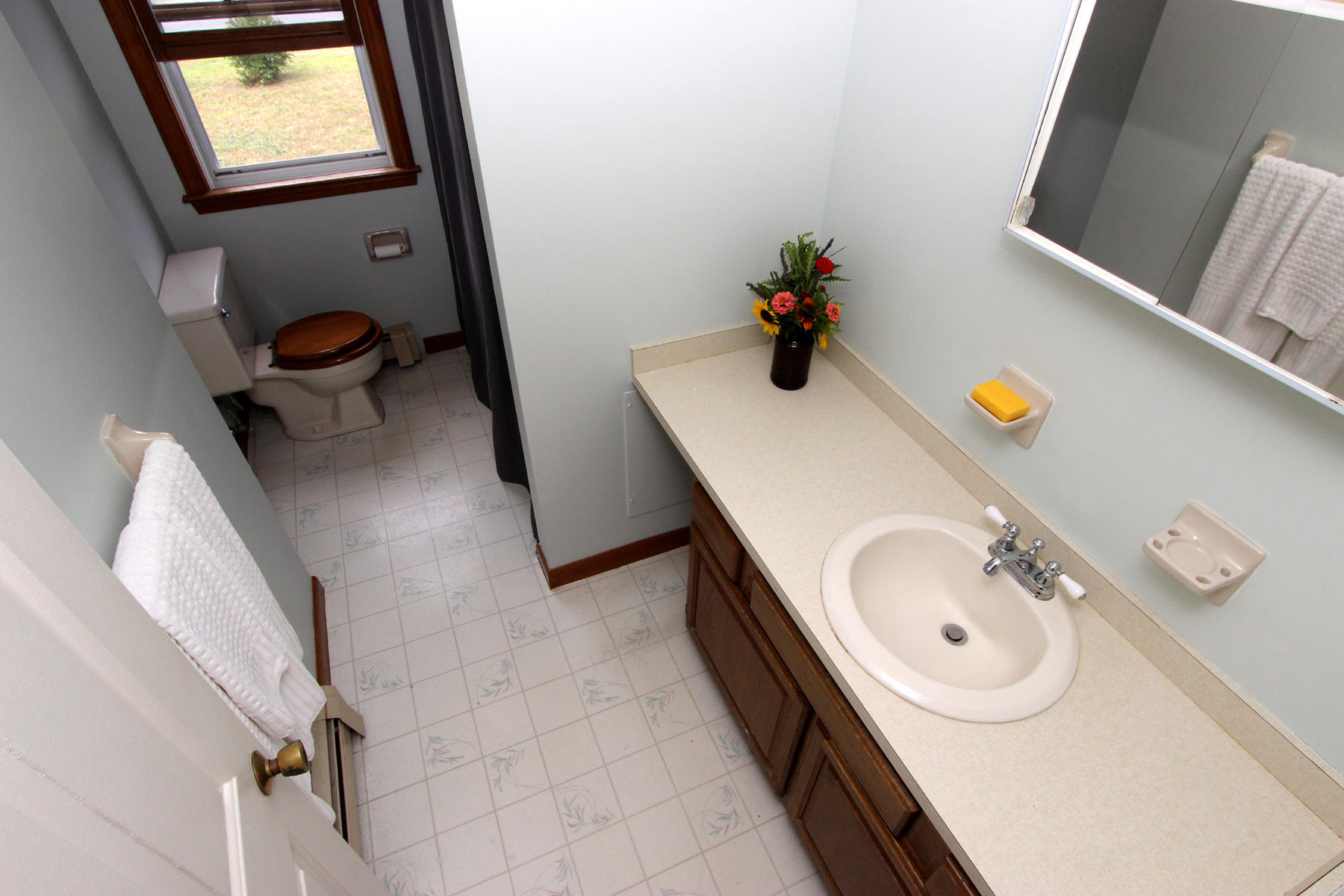 58 Colburne Path West Yarmouth, MA 02673 - Photo 37 of 39 a bathroom with a granite countertop sink a toilet and mirror