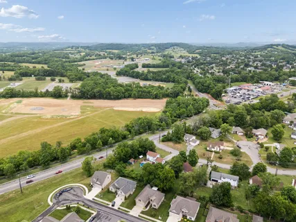 an aerial view of ocean and residential houses with outdoor space