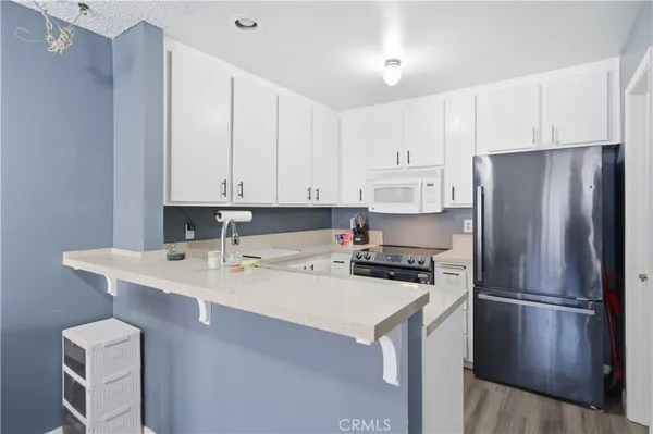 a kitchen with stainless steel appliances a refrigerator sink and cabinets