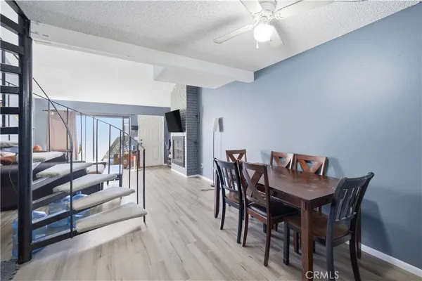 a dining room with furniture and wooden floor