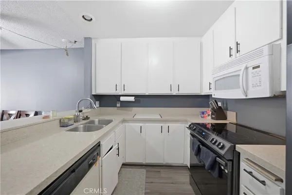 a kitchen that has a sink and a stove in it