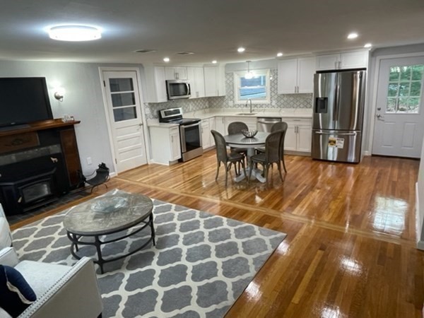 6 Hickey Road Hingham, MA 02043 - Photo 5 of 23 a kitchen with stainless steel appliances granite countertop a sink a stove a refrigerator cabinets and chairs