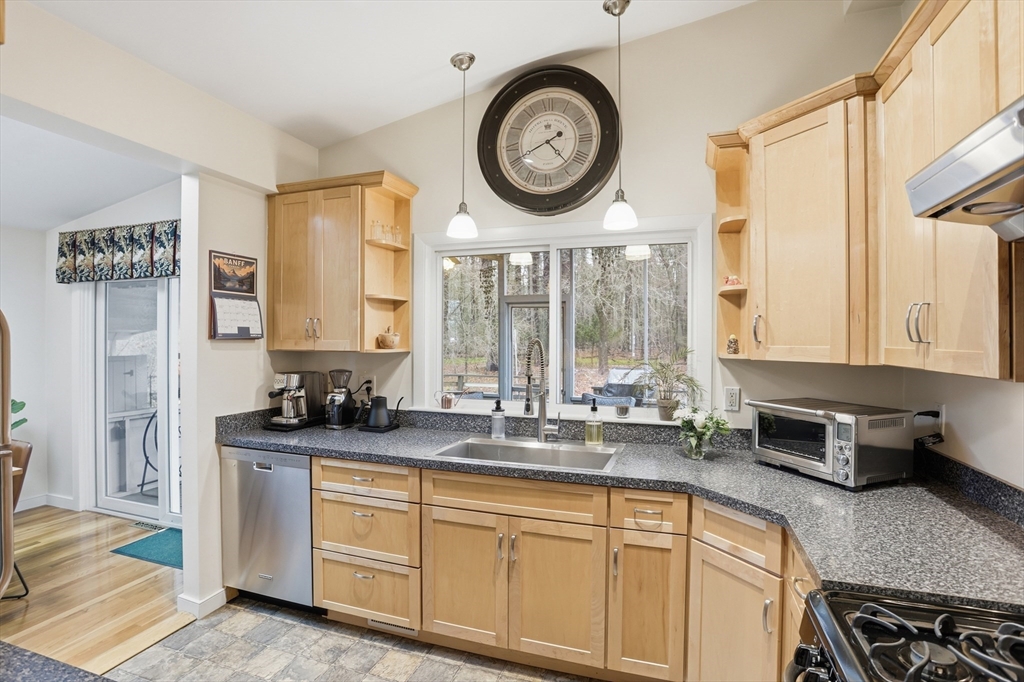 69 Robbins Road Sudbury, MA 01776 - Photo 12 of 35 a kitchen with stainless steel appliances granite countertop a stove a sink and a granite countertops
