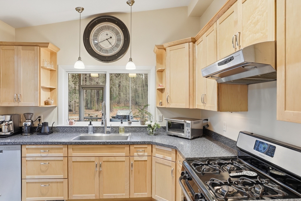 69 Robbins Road Sudbury, MA 01776 - Photo 13 of 35 a kitchen with a stove a clock and a sink