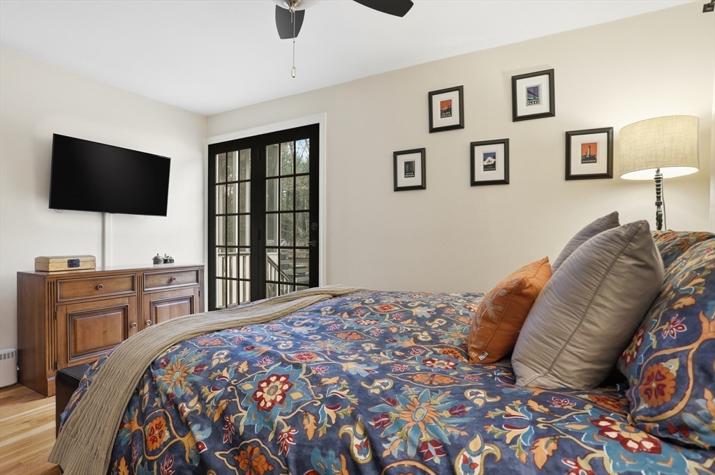 69 Robbins Road Sudbury, MA 01776 - Photo 16 of 35 a bedroom with a bed and a flat screen tv