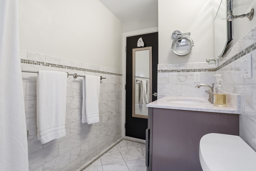 69 Robbins Road Sudbury, MA 01776 - Photo 18 of 35 a bathroom with a sink a toilet and a mirror