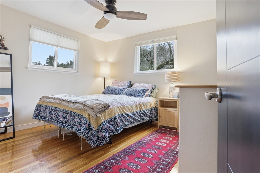 69 Robbins Road Sudbury, MA 01776 - Photo 19 of 35 a bedroom with a bed and a painting on the wall