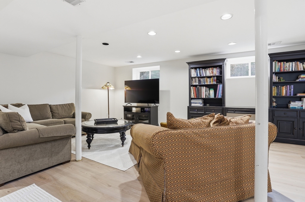 69 Robbins Road Sudbury, MA 01776 - Photo 24 of 35 a living room with furniture and a flat screen tv