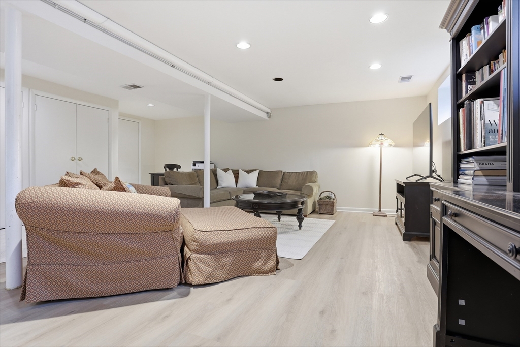 69 Robbins Road Sudbury, MA 01776 - Photo 25 of 35 a living room with furniture and a flat screen tv