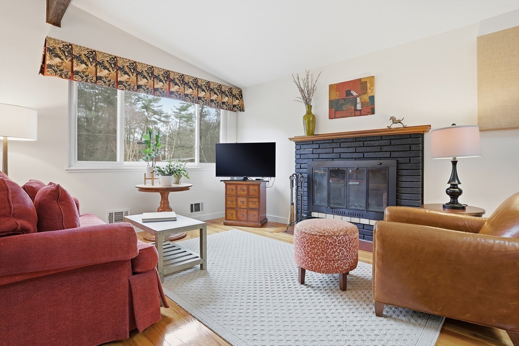 69 Robbins Road Sudbury, MA 01776 - Photo 4 of 35 a living room with furniture a flat screen tv and a fireplace