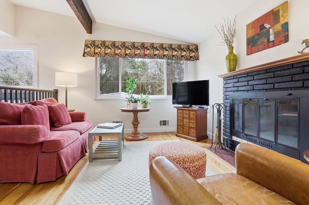 69 Robbins Road Sudbury, MA 01776 - Photo 5 of 35 a living room with furniture a flat screen tv and a floor to ceiling window